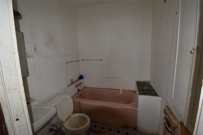 Full bath with a bathtub, radiator, and tile walls | Image 10