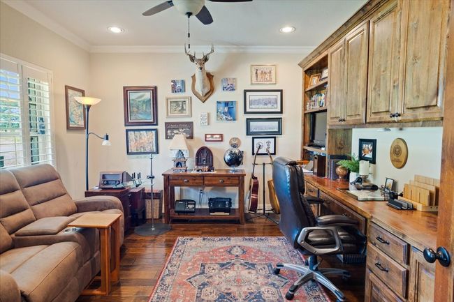 Office space featuring dark wood-type flooring, ceiling fan, ornamental molding, and recessed lighting | Image 5