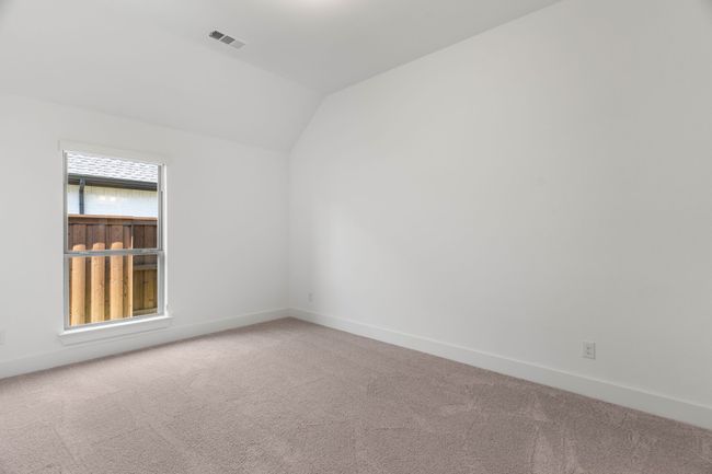 Carpeted empty room with lofted ceiling and baseboards | Image 14