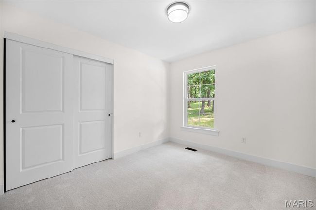 Unfurnished bedroom featuring carpet floors and a closet | Image 28
