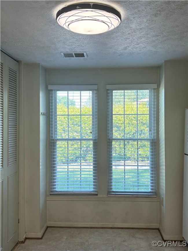Detailed view of a textured ceiling and freestanding refrigerator | Image 4