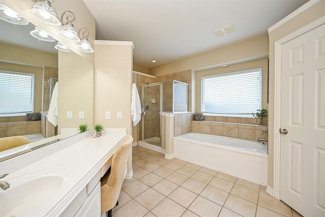 Ensuite primary bathroom designed for comfort. | Image 16