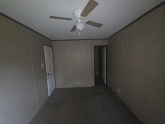 Spare room with a ceiling fan and ornamental molding | Image 16