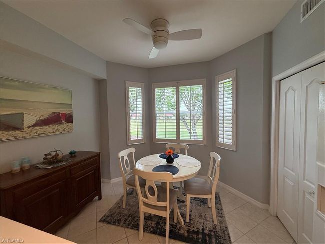 Dining room featuring ceiling fan, light tile patterned floors, and baseboards | Image 4