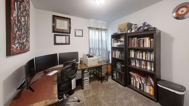 Office space featuring carpet floors and a textured ceiling | Image 32
