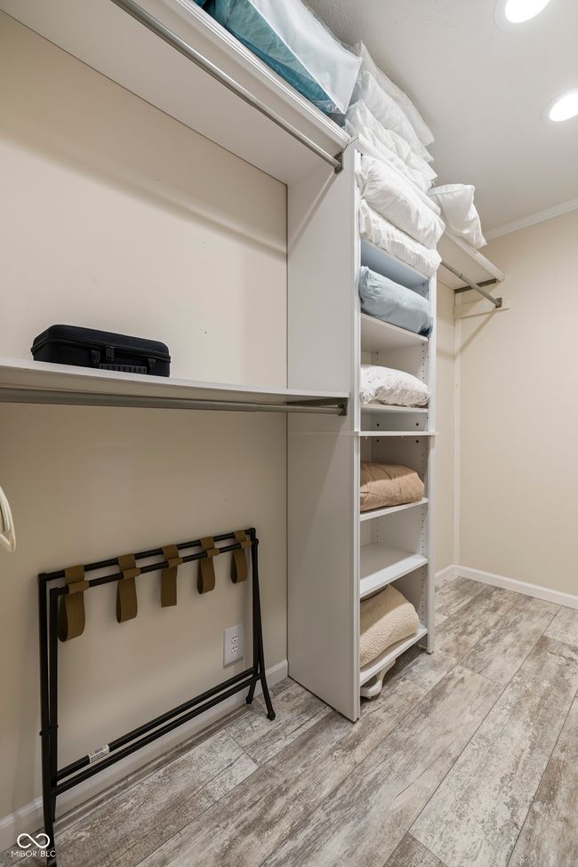 walk in closet featuring wood finished floors | Image 28