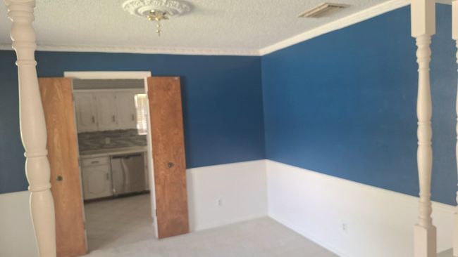 Unfurnished dining room with a textured ceiling | Image 13