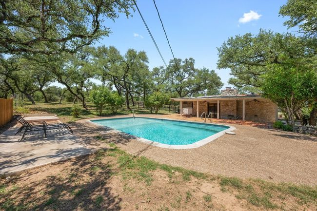 View of swimming pool with a patio area | Image 25