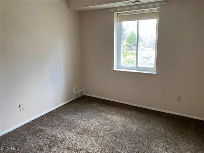 Empty room featuring baseboards, carpet flooring, and visible vents | Image 12