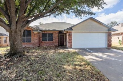 Ranch-style home featuring a garage | Image 2