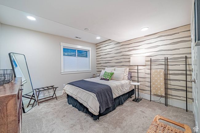 Bedroom featuring an accent wall, wallpapered walls, carpet flooring, baseboards, and recessed lighting | Image 21