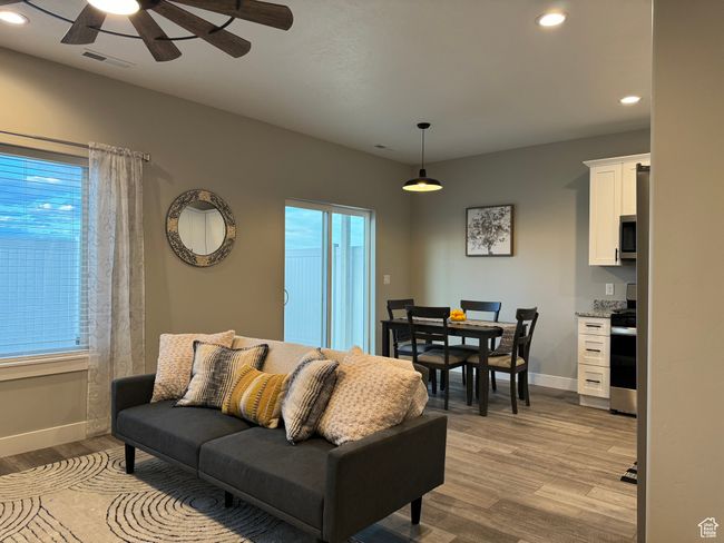 Living room with ceiling fan and light hardwood / wood-style floors | Image 12