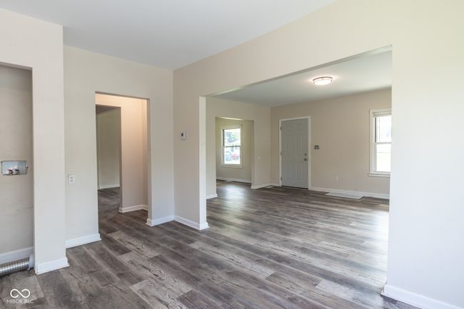 unfurnished room with baseboards, plenty of natural light, and dark wood-type flooring | Image 19