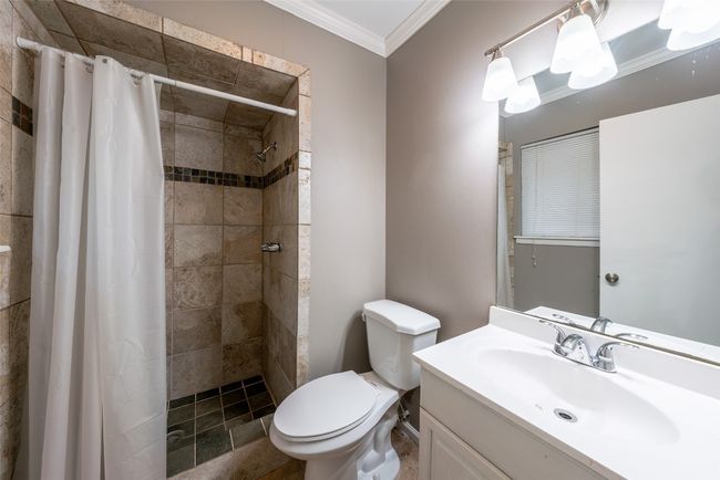 Full bathroom featuring ornamental molding, vanity, and tiled shower | Image 22