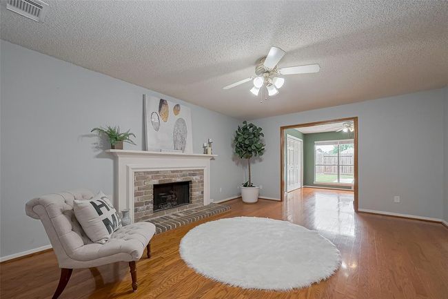 The family room features a cozy fireplace, creating a warm and inviting focal point for gatherings or quiet evenings at home. | Image 11