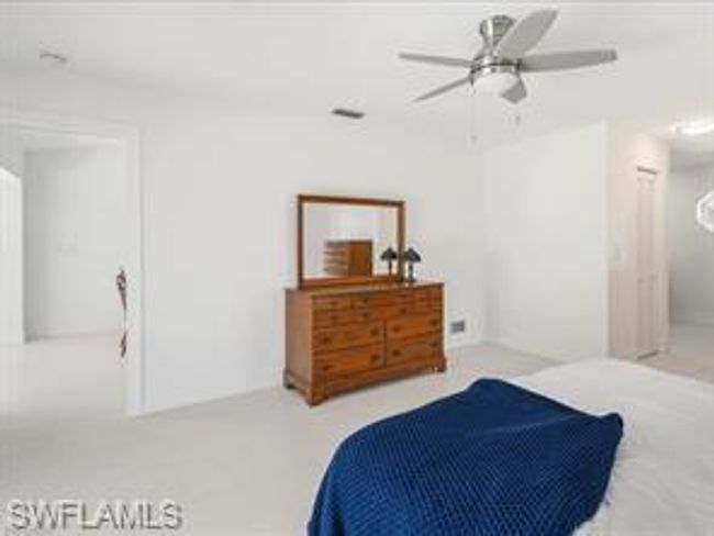 Carpeted bedroom with ceiling fan | Image 13