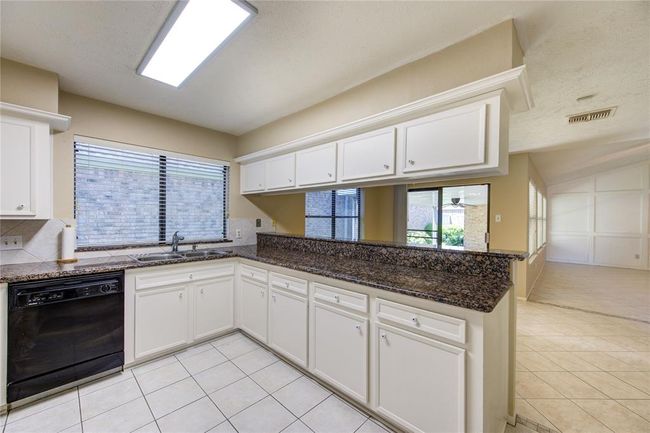 Kitchen and breakfast bar, looking towards the dining and family room. | Image 13