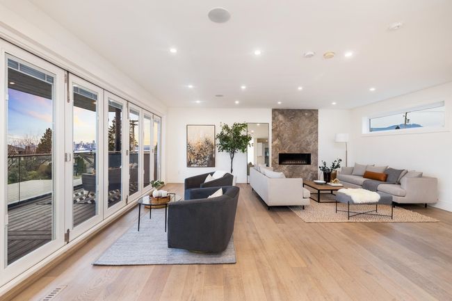 Living room with recessed lighting, light wood-style floors, and a premium fireplace | Image 13