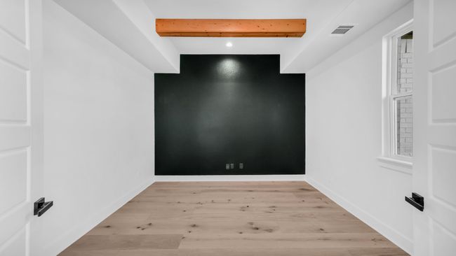 Unfurnished room with visible vents, beamed ceiling, baseboards, and light wood-style floors | Image 6