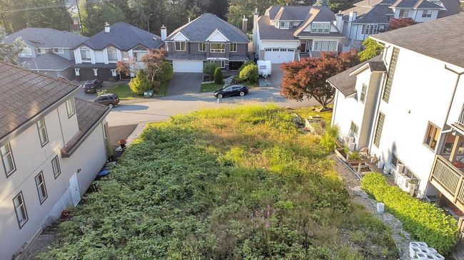 View of yard with an attached garage, concrete driveway, and a residential view | Image 13