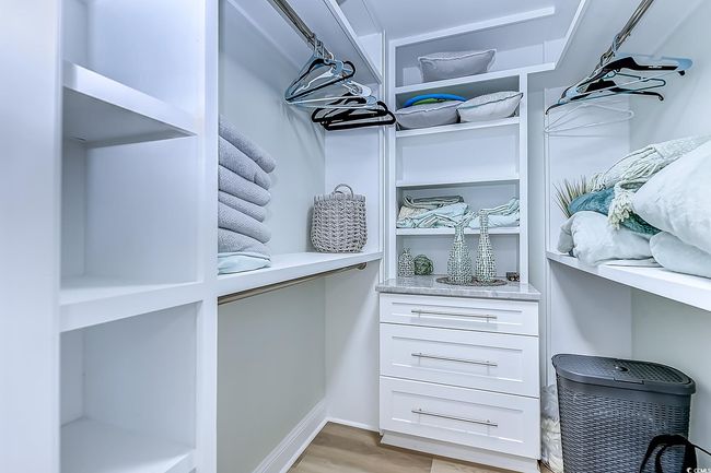 Walk in closet featuring light hardwood / wood-style flooring | Image 25