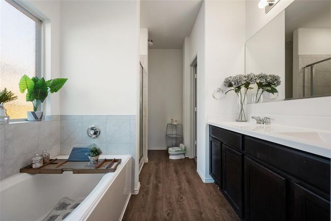 Bathroom with a shower stall, a garden tub, plenty of natural light, and double vanity | Image 16