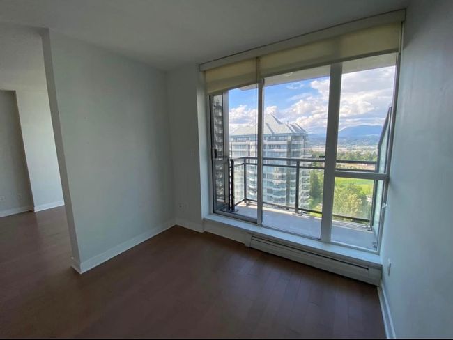Unfurnished room featuring baseboards, a baseboard heating unit, and dark wood-type flooring | Image 9