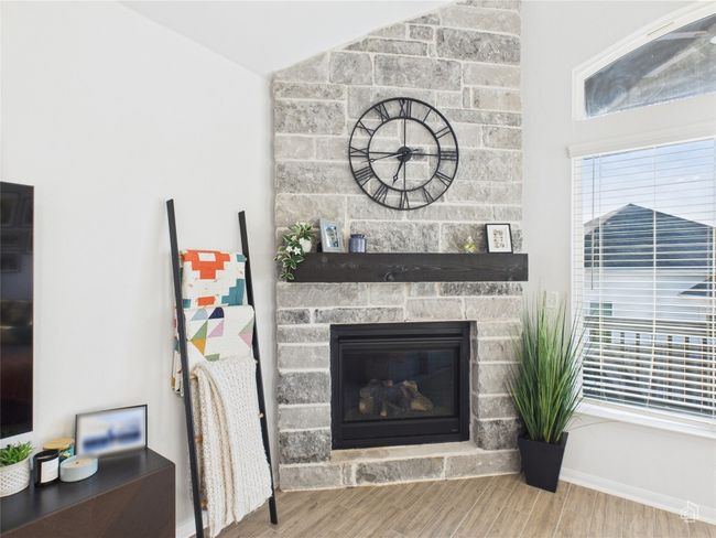 Detailed view of wood finished floors, a fireplace, and baseboards | Image 18