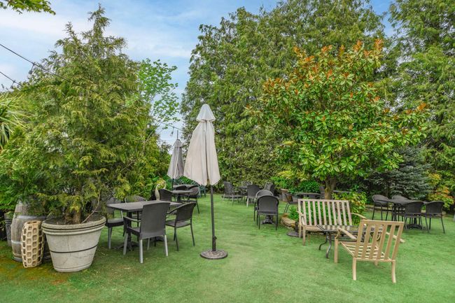 View of grassy yard featuring outdoor dining area | Image 31