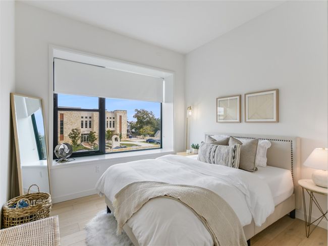 Bedroom with light wood finished floors and baseboards | Image 17