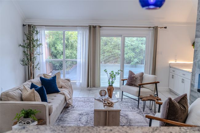 Living room with ornamental molding, plenty of natural light, and light marble finish floors | Image 18