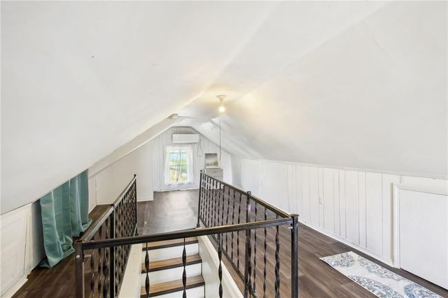 Additional living space featuring lofted ceiling, wood finished floors, and a decorative wall | Image 21