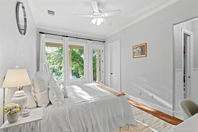 Bedroom featuring crown molding, visible vents, baseboards, and a ceiling fan | Image 21