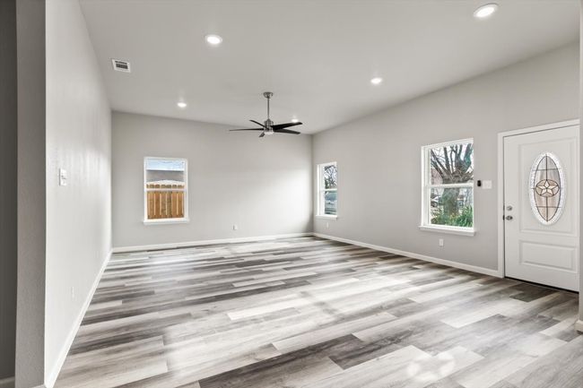 Foyer with ceiling fan and light wood-type flooring | Image 6