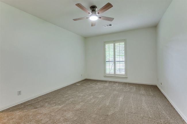 Corner bedroom faces south also and has a walk-in closet, new carpet and new fan. | Image 16