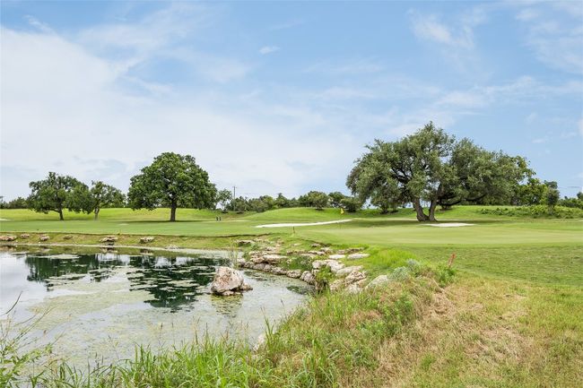 View of community featuring a lawn and golf course view | Image 38