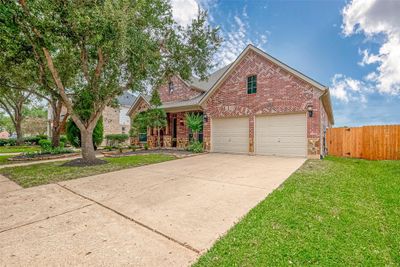 Welcome to this exquisite single-story Highland home, built in 2007, offering a charming stone and brick elevation that enhances its curb appeal. From the moment you arrive, you’ll love the spacious covered front patio, perfect for enjoying peaceful mornings or relaxing evenings with friends and family. | Image 2