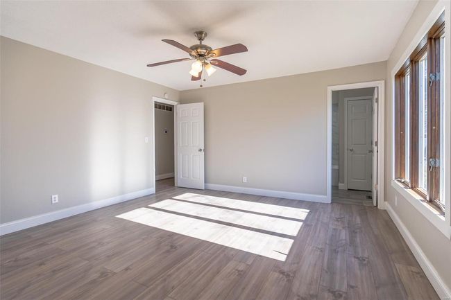 Unfurnished bedroom featuring wood-style flooring and ceiling fan | Image 21