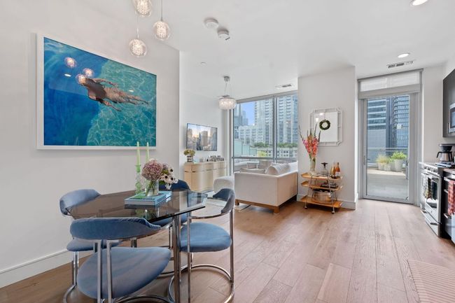 Dining room featuring wood-type flooring, baseboards, recessed lighting, and a view of city | Image 8