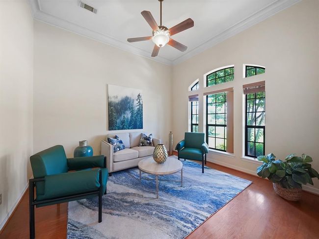Bright and inviting room immediately to the right, featuring large windows for natural light and elegant wood flooring. Perfect for a cozy sitting area or family room for a relaxing place to entertain! | Image 7