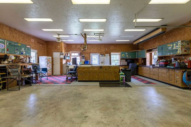 Detached workshop is spacious enough for ATVs, full size trucks, wood working, "man cave" and most other hobbies. There is an upstairs area for game rooms or additional living quarters. (window unit ACs) | Image 28
