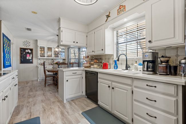 Kitchen with white cabinetry, dishwasher, and sink | Image 13