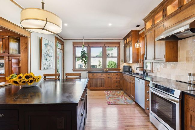 Gorgeous gourmet kitchen remodel/expansion provides, a rare for the era, opportunity to have a spacious and bright space to gather & cook. | Image 4