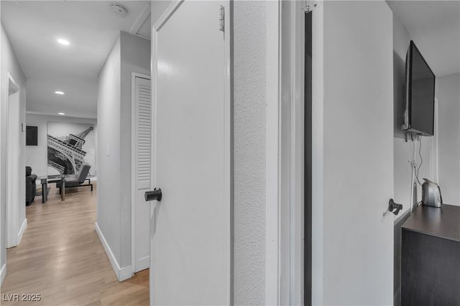 Hallway featuring light wood finished floors, recessed lighting, and baseboards | Image 37