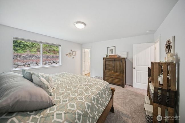Primary bedroom has plenty of space a warm inviting bedrooom. | Image 14