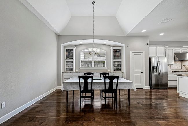 Dining space with a chandelier, lofted ceiling, dark wood finished floors, and recessed lighting | Image 13