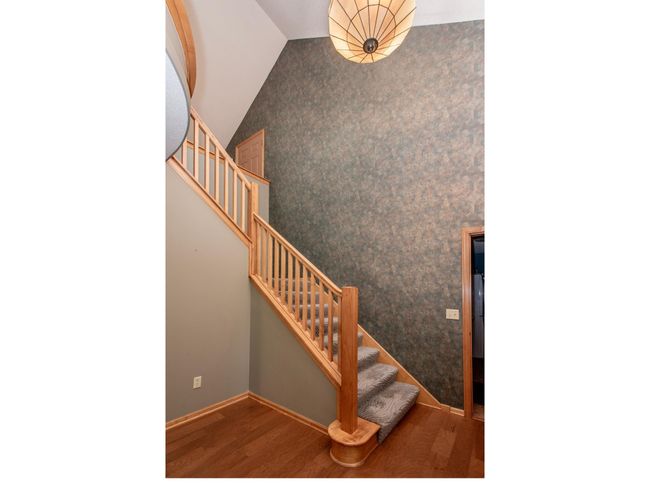The entryway impresses with its two-story height, vaulted ceiling and hardwood flooring. | Image 5