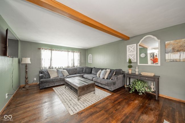 living room featuring beamed ceiling, baseboards, and wood finished floors | Image 37