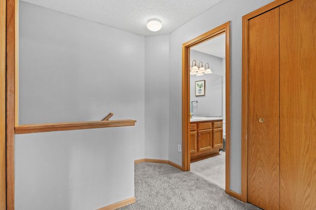 Spacious upper-level hallway with easy access to bedrooms, full bath, and laundry. | Image 15