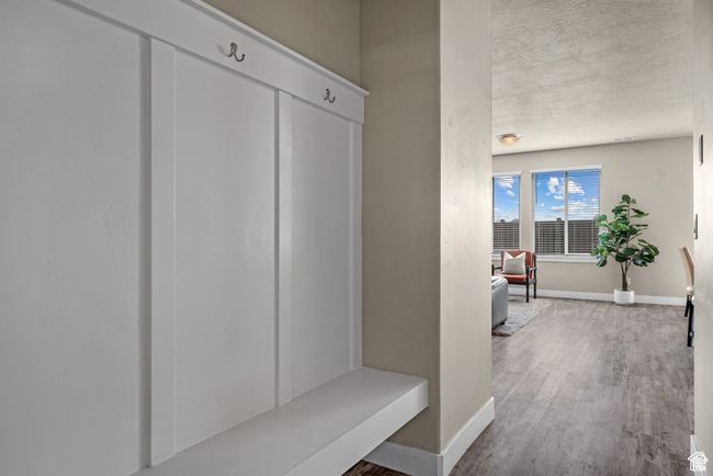 Mudroom with baseboards and wood finished floors | Image 21
